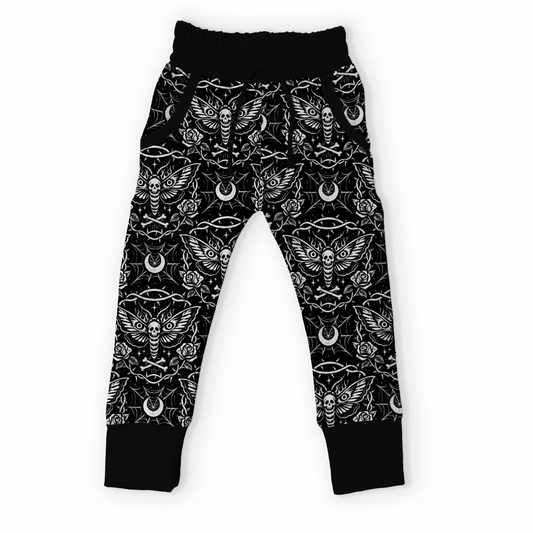 Black pants with white pattern featuring a goth / rock print with dead head moth. 