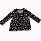 Black long-sleeve peplum shirt with white bone pattern on a white background