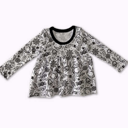 Peplum top from MySpookyBaby, white with black spooky cute design ; bats, spiderwebs, treats. Black neckline. 