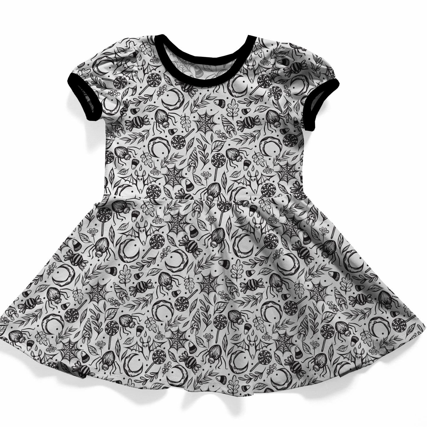 Spooky cute dress, black and white patterned. The print is white with black bats, spiderwebs, moons, leaves, and candies. 