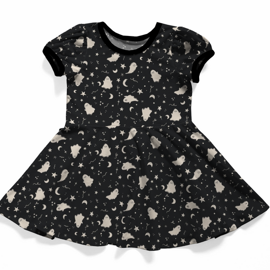 Goth baby dress black with ghosts, moons and stars in white. Black neckband and black sleeve bands. 
Handmade by My Spooky Baby. 