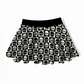 Skirt with black and white skull checkered pattern on a white background