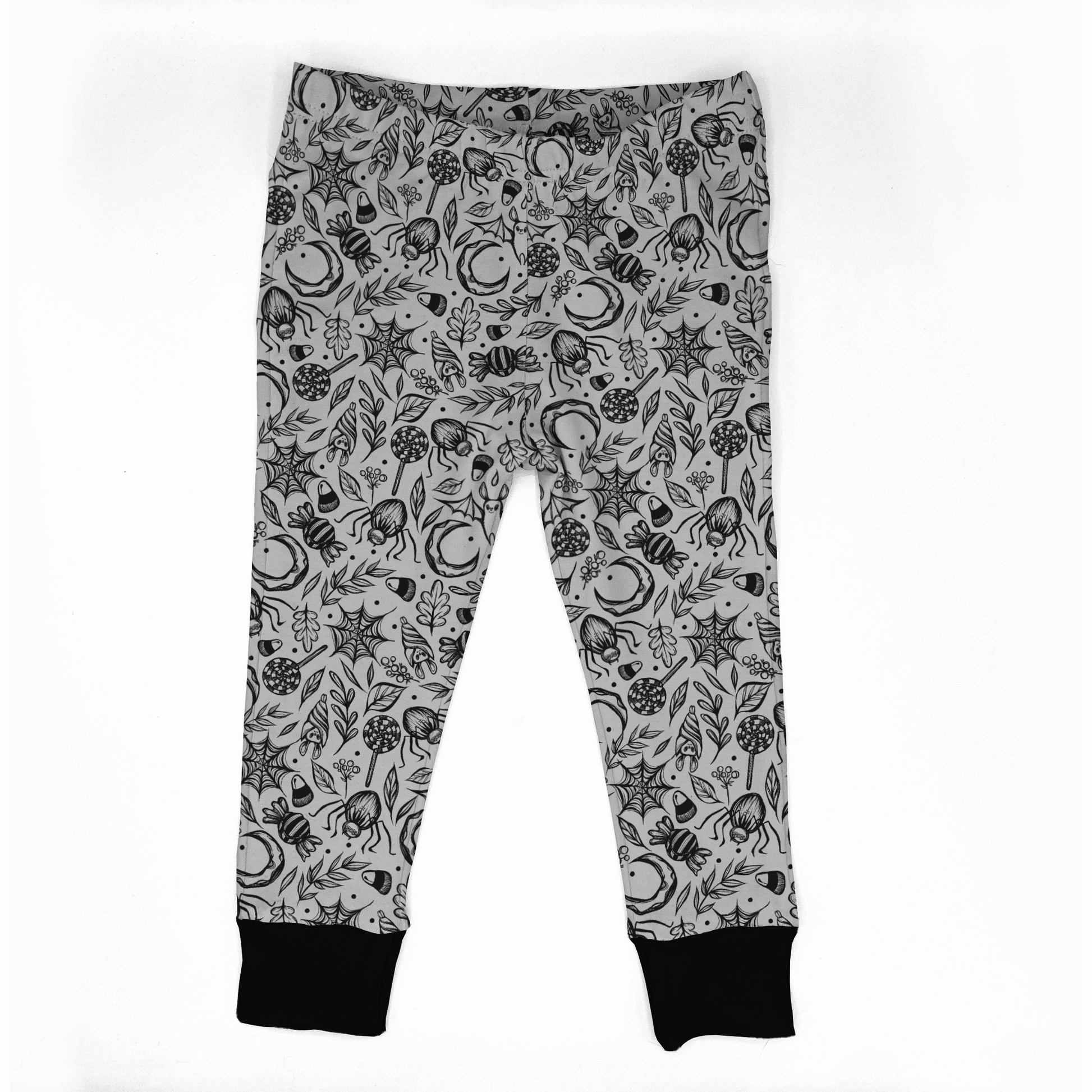Spooky cute leggings, white with black designs : spiderwebs, spiders, bats, leaves, moons, and candies. Black cuffs at legs. Elasticat at waistband. 
