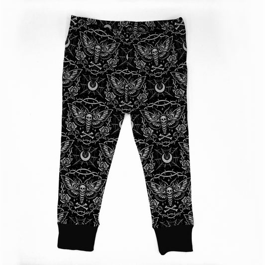 Goth baby leggings, black with white designs on it : dead head moth, roses, moons and spiderwebs. Black cuff at legs. Elastic at waistband. 